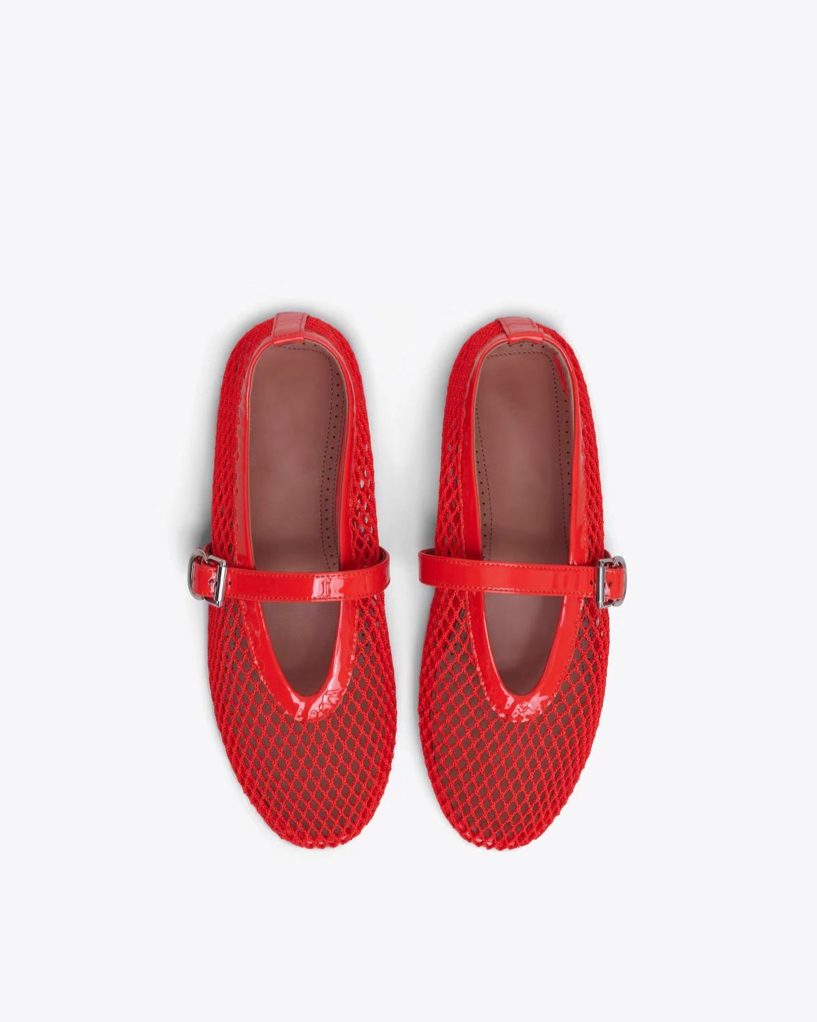 Pair of red mesh shoes with buckles on a white background