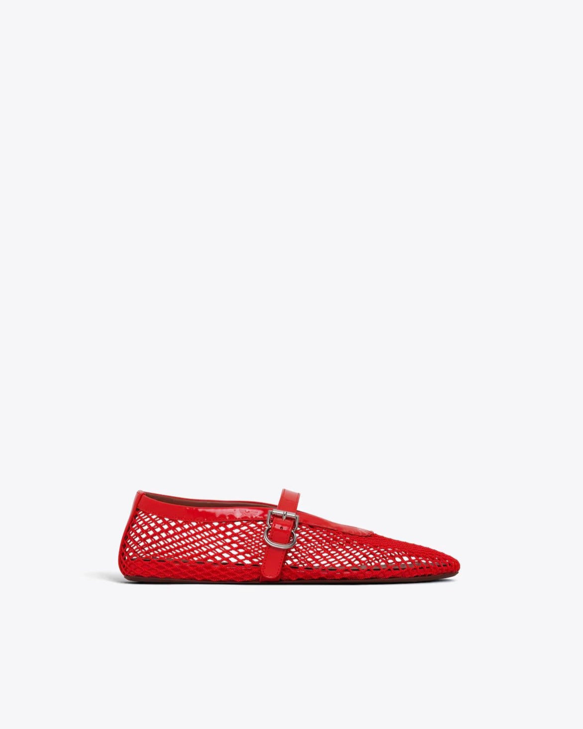 Red perforated flat shoe with a buckle on a white background